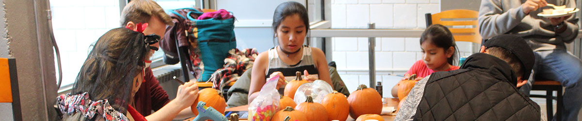 Students decorate pumpkins with their families for Day of the Dead in the BCC cafeteria
