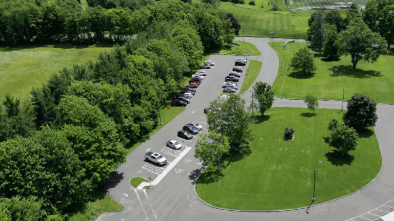 Car driving through visitor lot