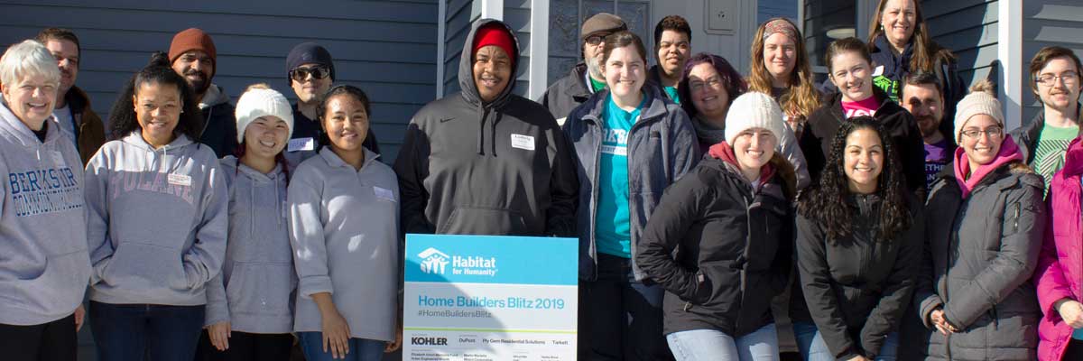 BCC employees holding a Habitat for Humanity sign