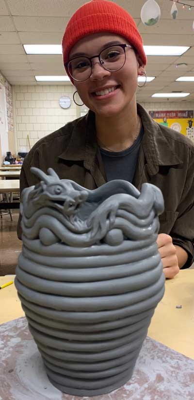 BCC Visual Arts student holding a ceramic piece