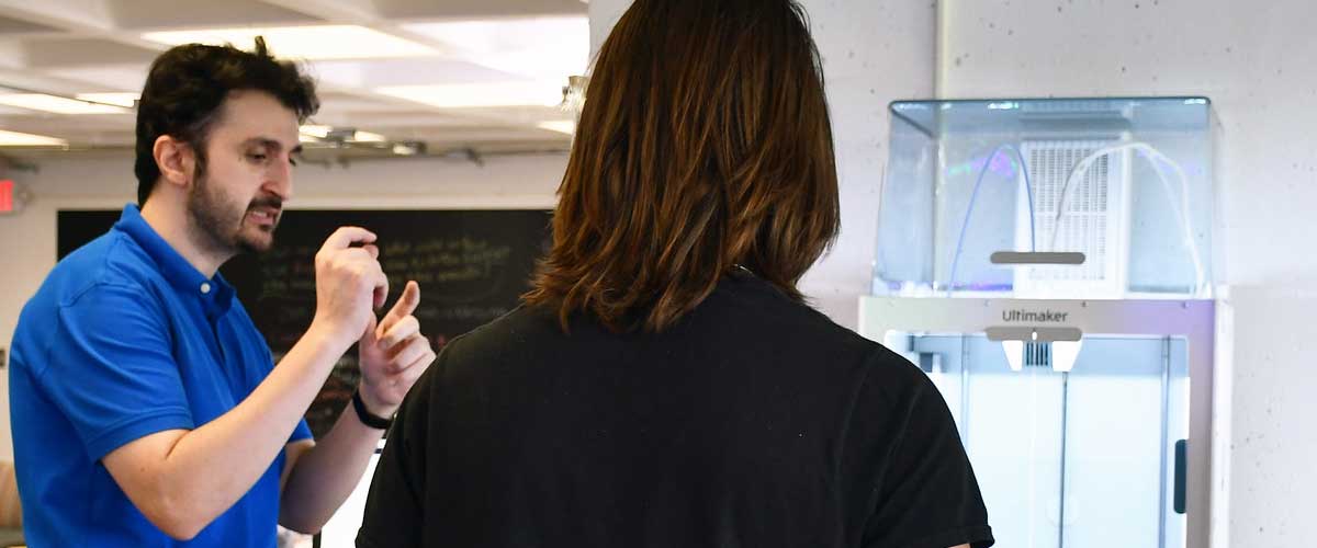 BCC instructor and student studying a 3D printer