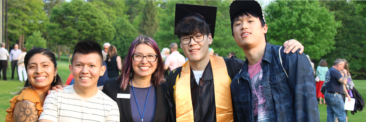 Multicultural students posing after BCC graduation ceremony