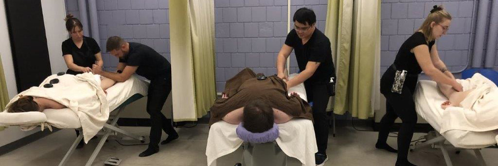 Students applying Massage Therapy skills in a class