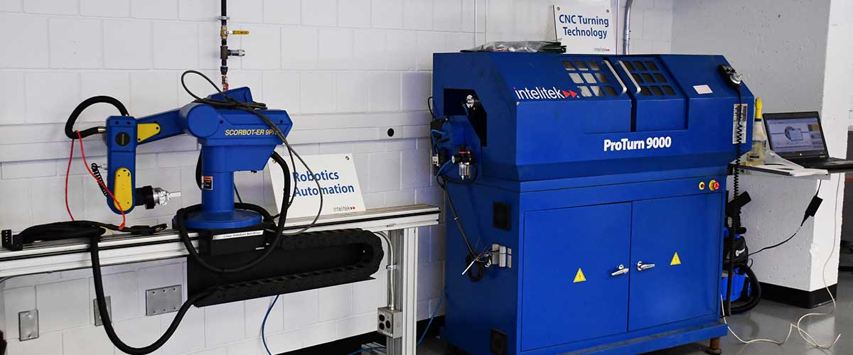 Instructors with manufacturing students