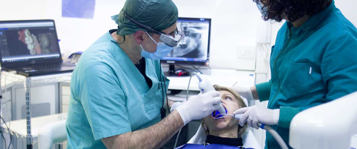 Dentist and dental assistant working on a patient