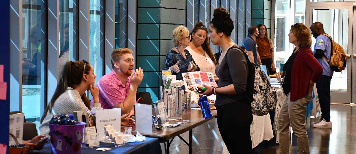 Students have a conversation while walking through the One Stop Center at BCC.