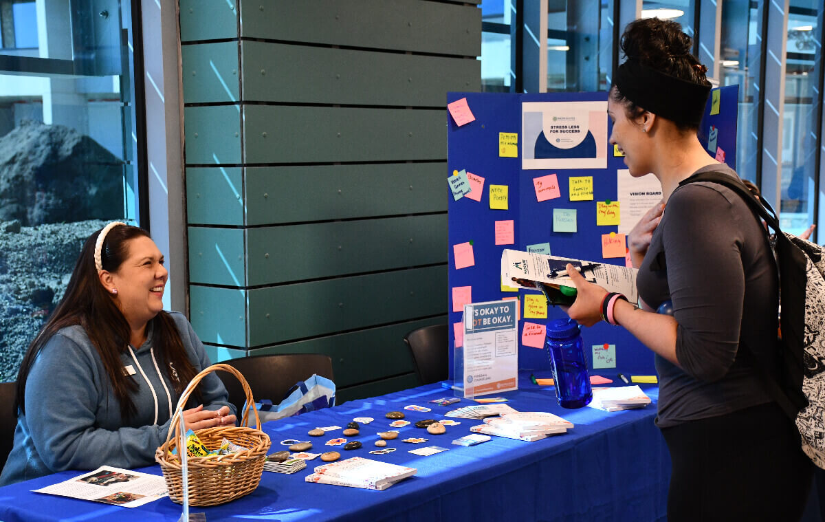 Students have a conversation while walking through the One Stop Center at BCC.